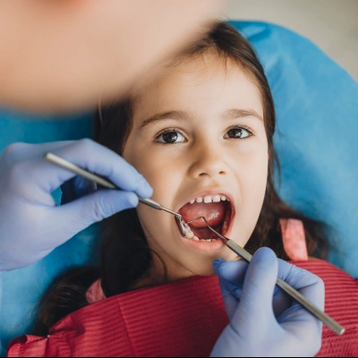 Expert pediatric dentist providing gentle care for child's healthy smile